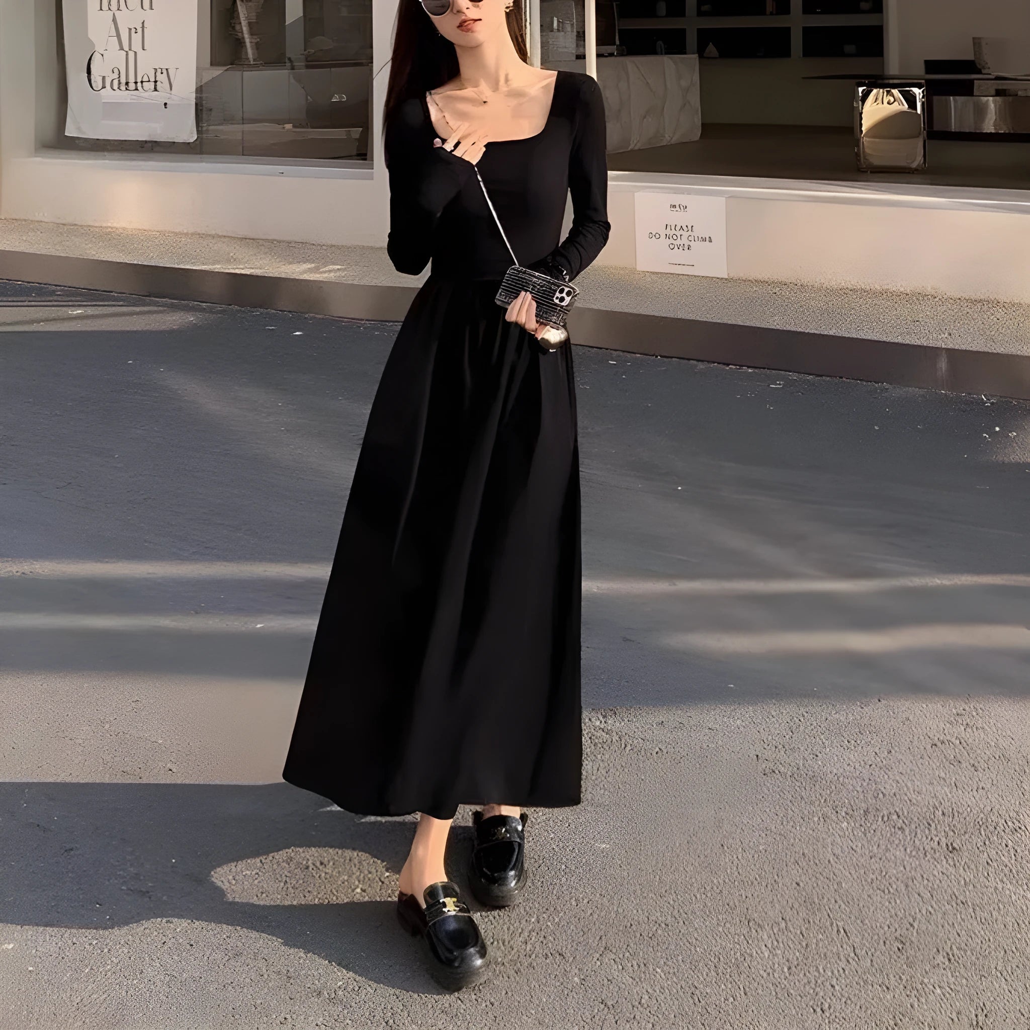 Women's black square collar knitted dress with long sleeves and an elastic A-line waist.