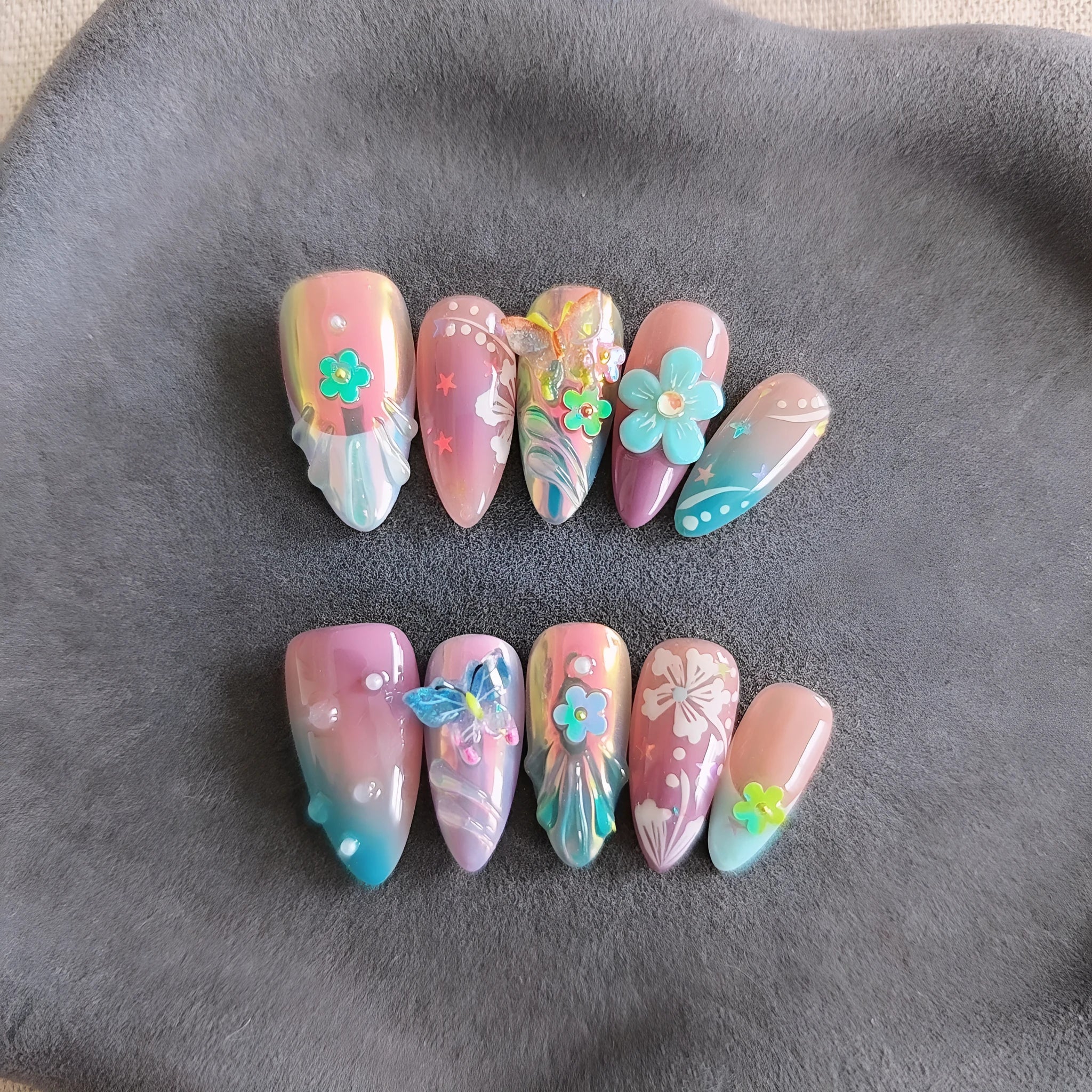 Handmade colourful nail sculptures with floral patterns and embossed butterfly designs