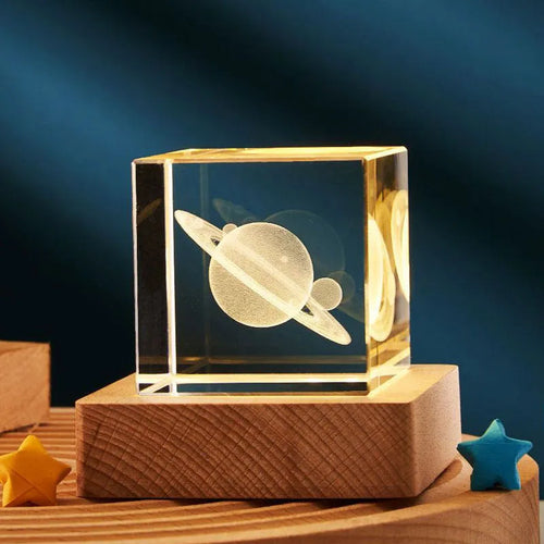 3D transparent crystal cube night lamp with warm light pattern on wooden desktop