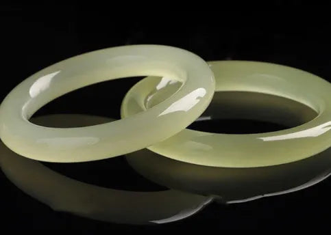Ice-like silk jade round bar bracelet on neutral background showing smooth surface and circular shape