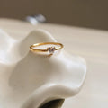 Golden stainless steel ring with heart shape on oval band, shown in size options 5 through 8