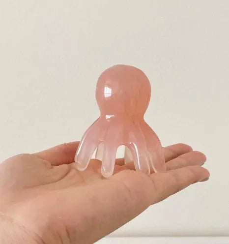 Pink octopus-shaped natural resin massage comb for facial and head massage with storage bag