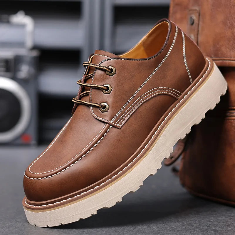 Men's black low top British retro worker boots with round toe and rubber sole.