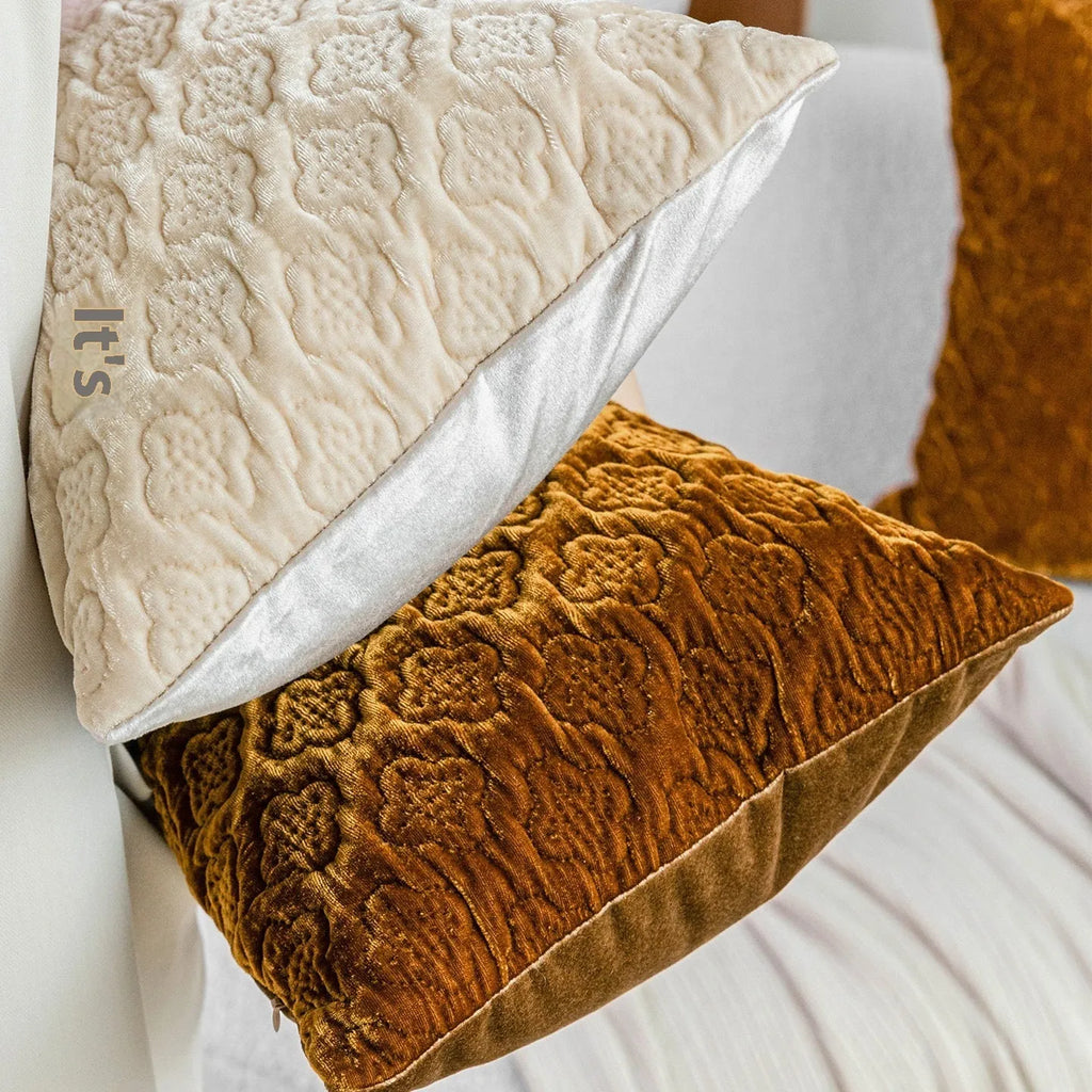 Brown gold antique-style quilted square cushion pillow with three-dimensional texture on a chair.