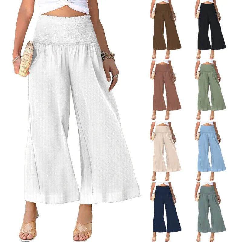 Women's high-waist pleated cotton trousers in a straight-leg cropped style on a neutral background.