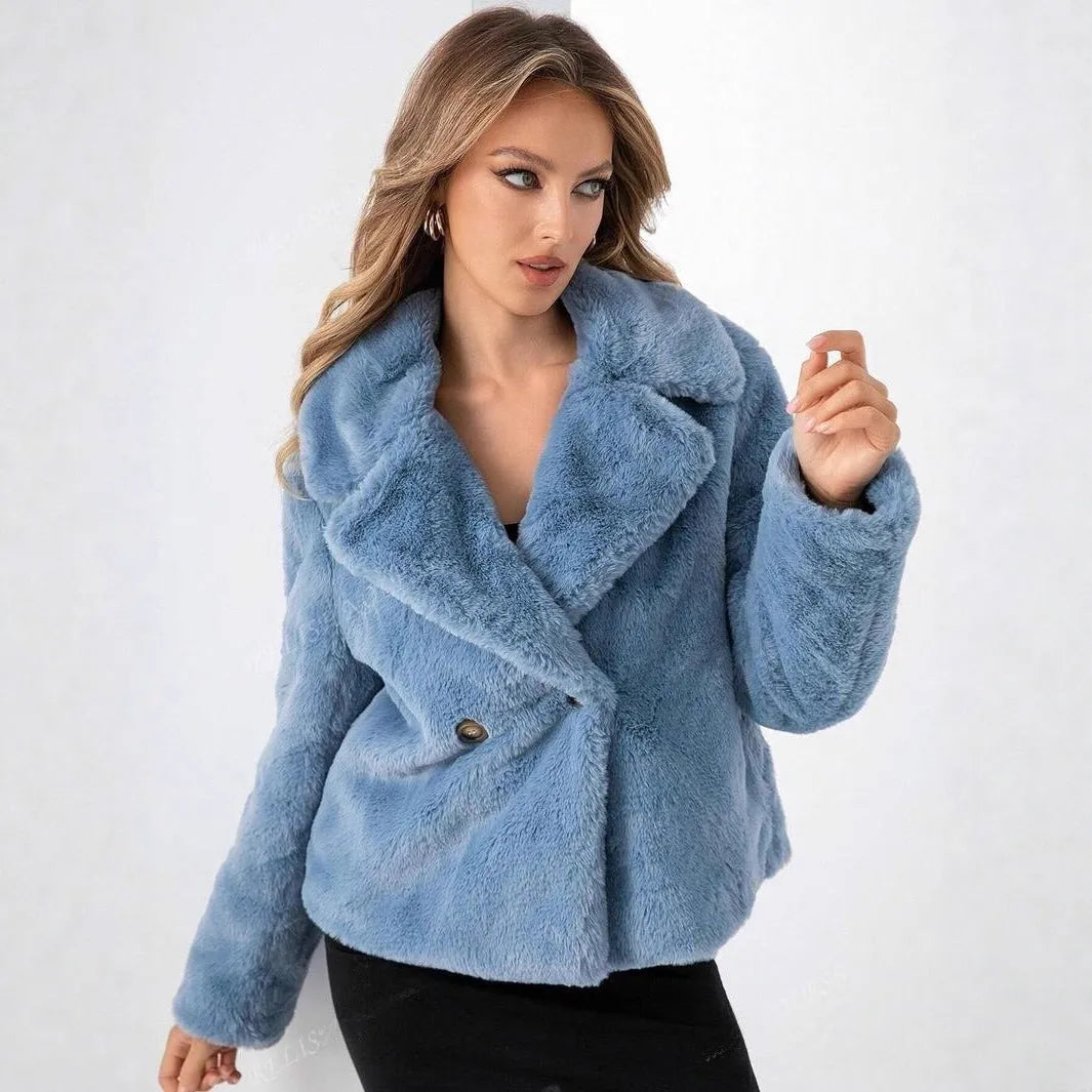 A rose red women's short loose faux fur coat with regular sleeves on a model.