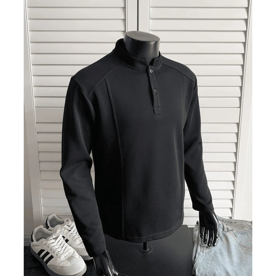 Man wearing a grey patchwork stand-up collar polo shirt with asymmetric shoulder detail