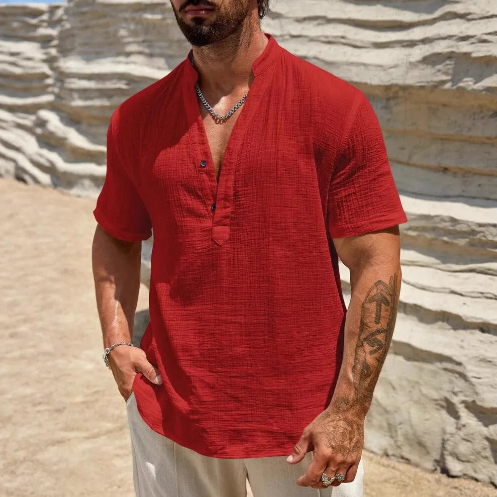 Men's solid colour stand collar short-sleeved shirt in a light blue shade, showing the slit detail and casual fit.