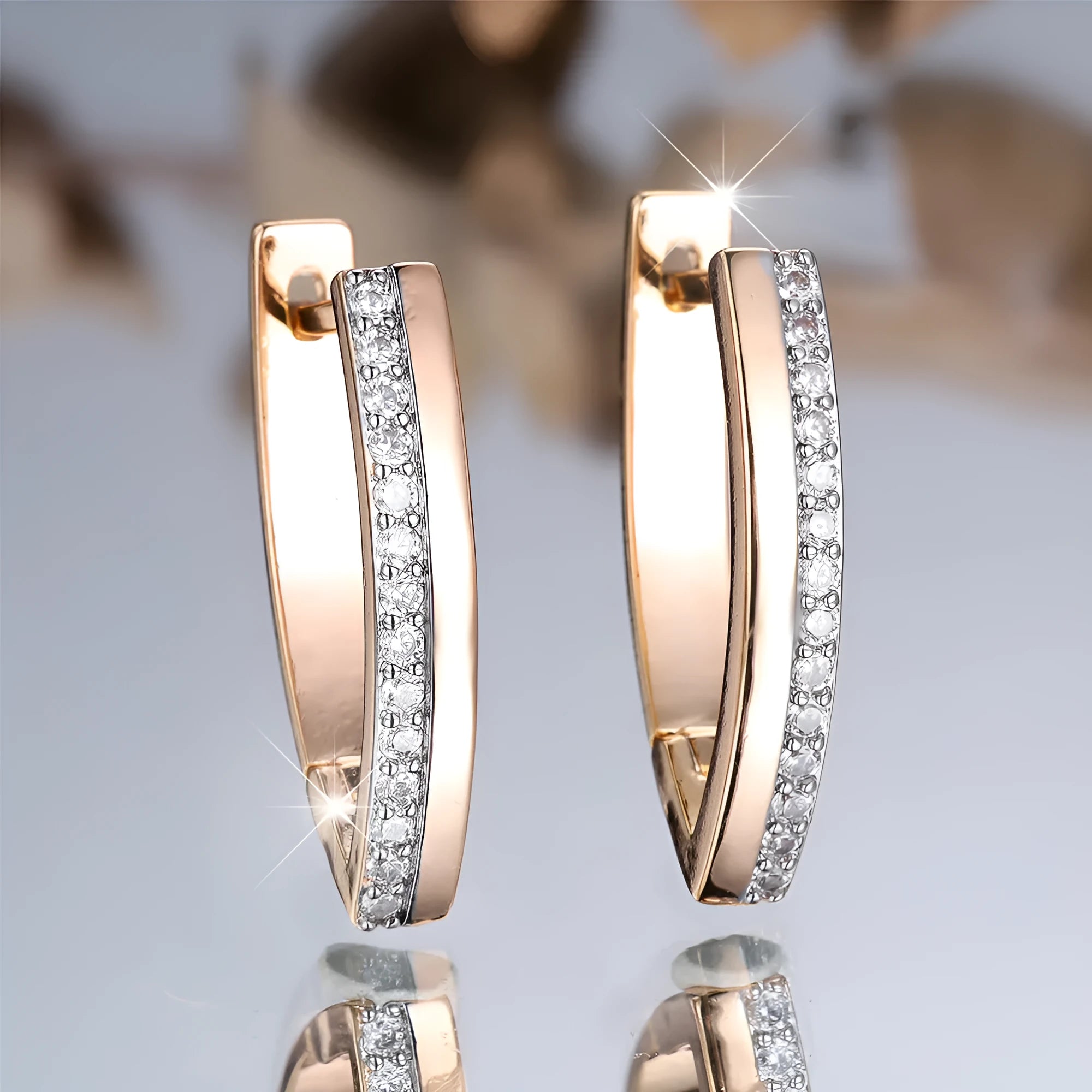 Women's V-shaped geometric copper ear clips in champagne gold with white diamond accents