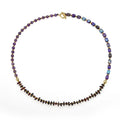 Amethyst round beads stone bracelet with purple garnet and geometric texture on plain background