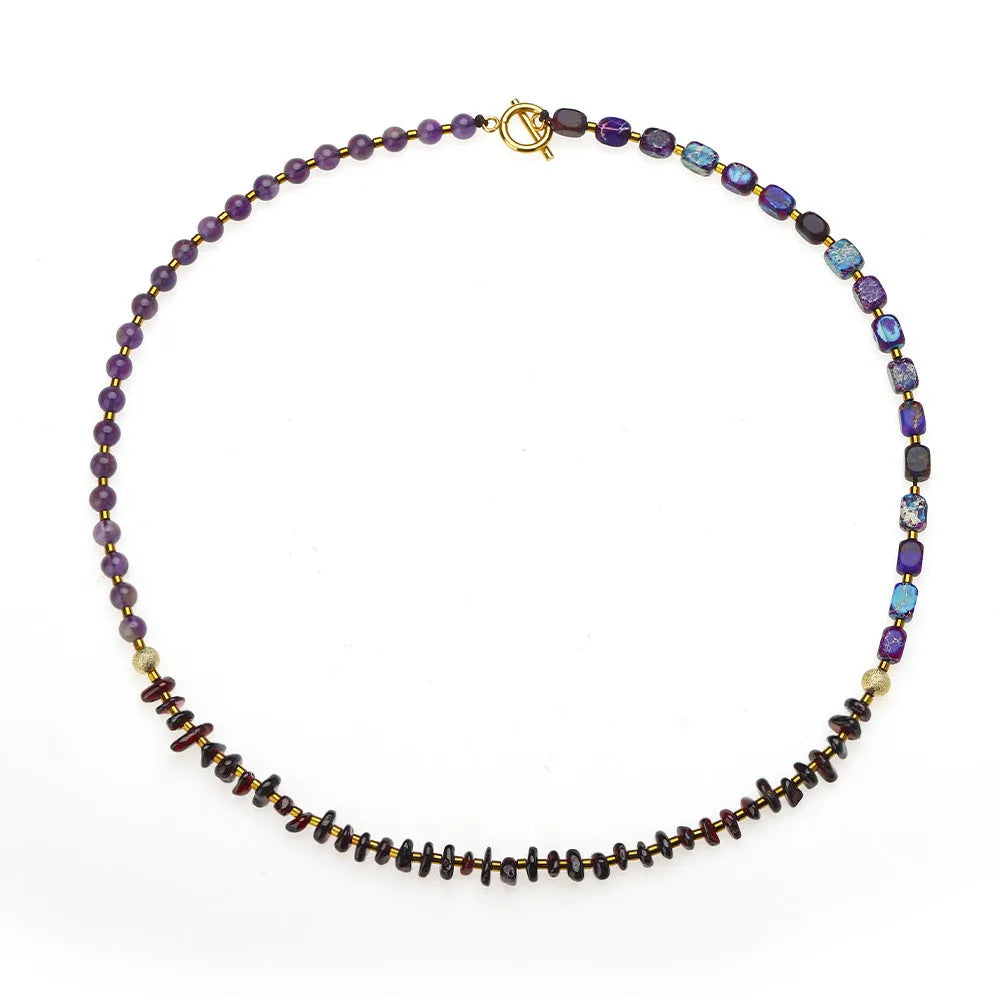 Amethyst round beads stone bracelet with purple garnet and geometric texture on plain background