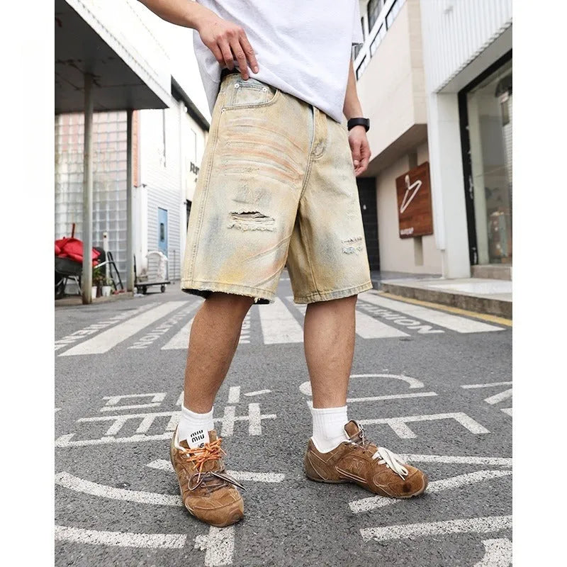 Men's light blue washed ripped straight-leg denim shorts on model front view