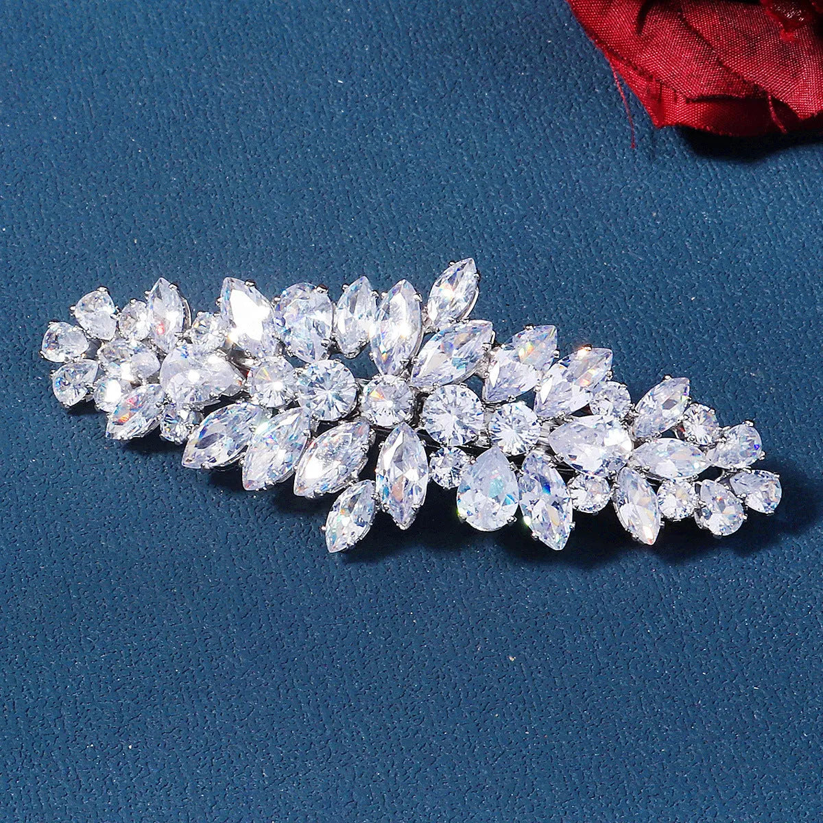 Women's inlaid zircon spring clip barrette with leaf pattern, electroplated finish, side view