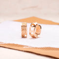 Rose gold circular earrings with three hollow heart cut-outs