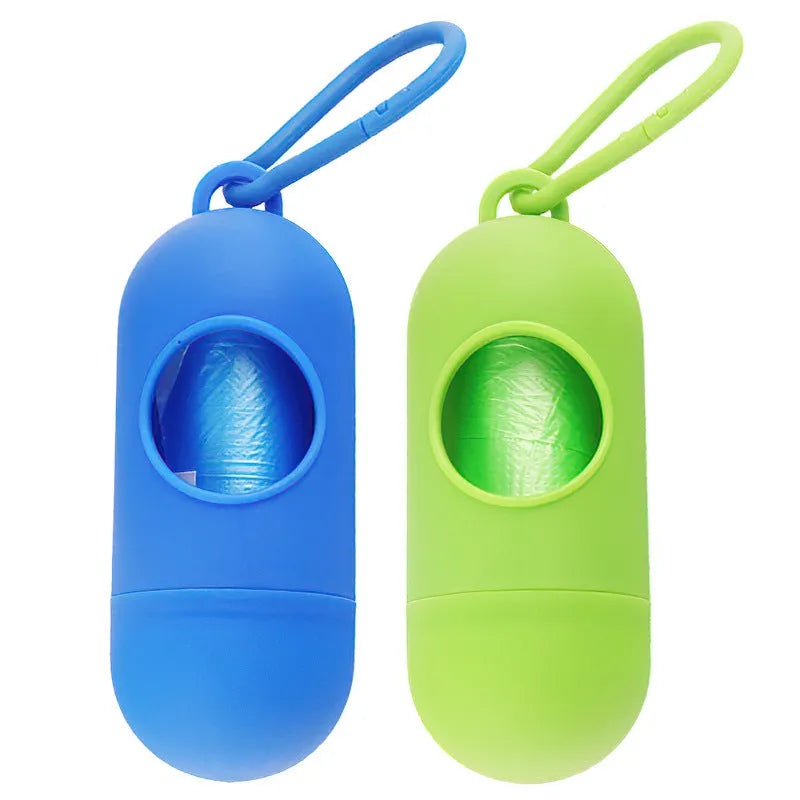 Compact black dog waste bag dispenser with a side hook and Velcro strap for attachment.