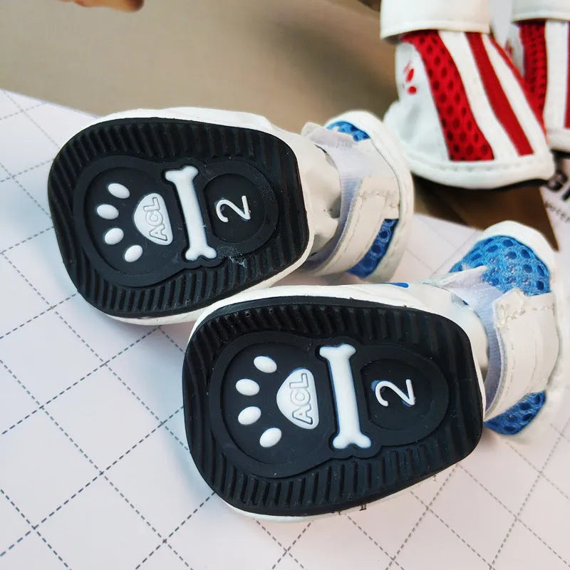 Four blue cloth dog sneakers with zipper closures and non-slip soles for small breeds