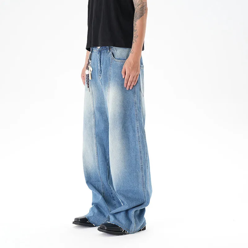 Light blue wide leg machete jeans with vintage washed denim finish, zip-fly closure, cut wash effect