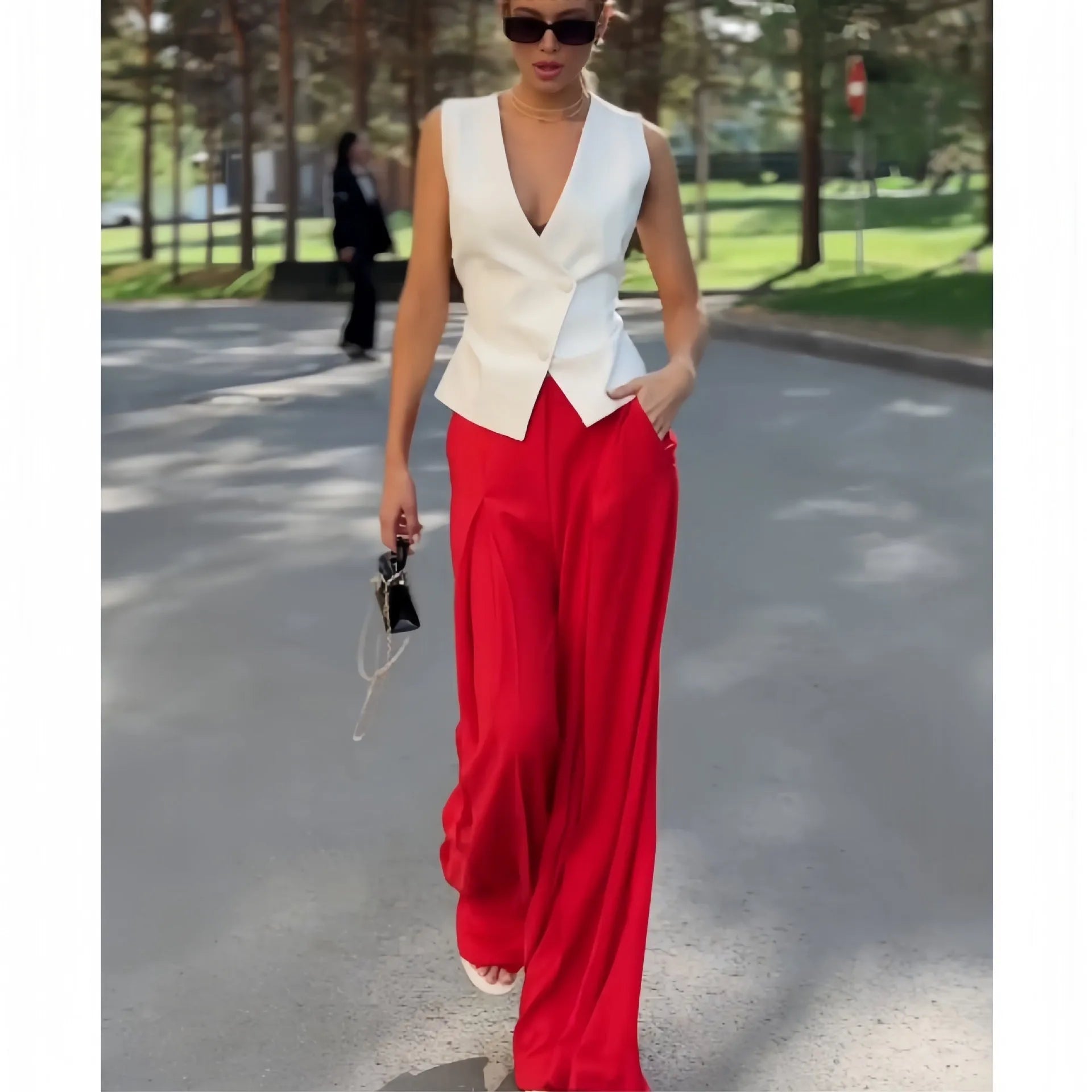Women's beige deep V-neck sleeveless top and high waist wide leg pants two-piece set on model