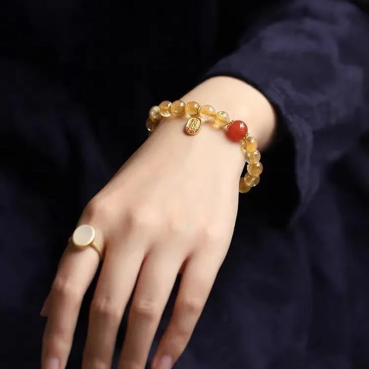 Natural red agate bracelet with gold ruby beads on a light background, polished finish, 8mm size