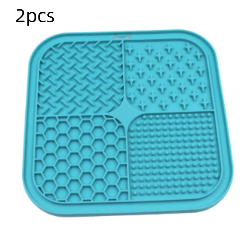 Green silicone pet licking pad 20x20cm with suction cup base on a tiled floor