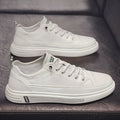 White casual men's shoes with round toe and flat low-heel design on neutral background