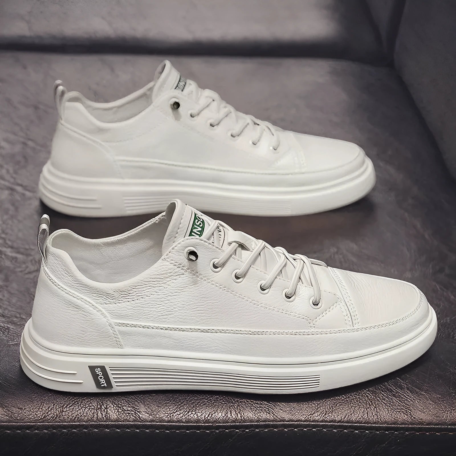 White casual men's shoes with round toe and flat low-heel design on neutral background
