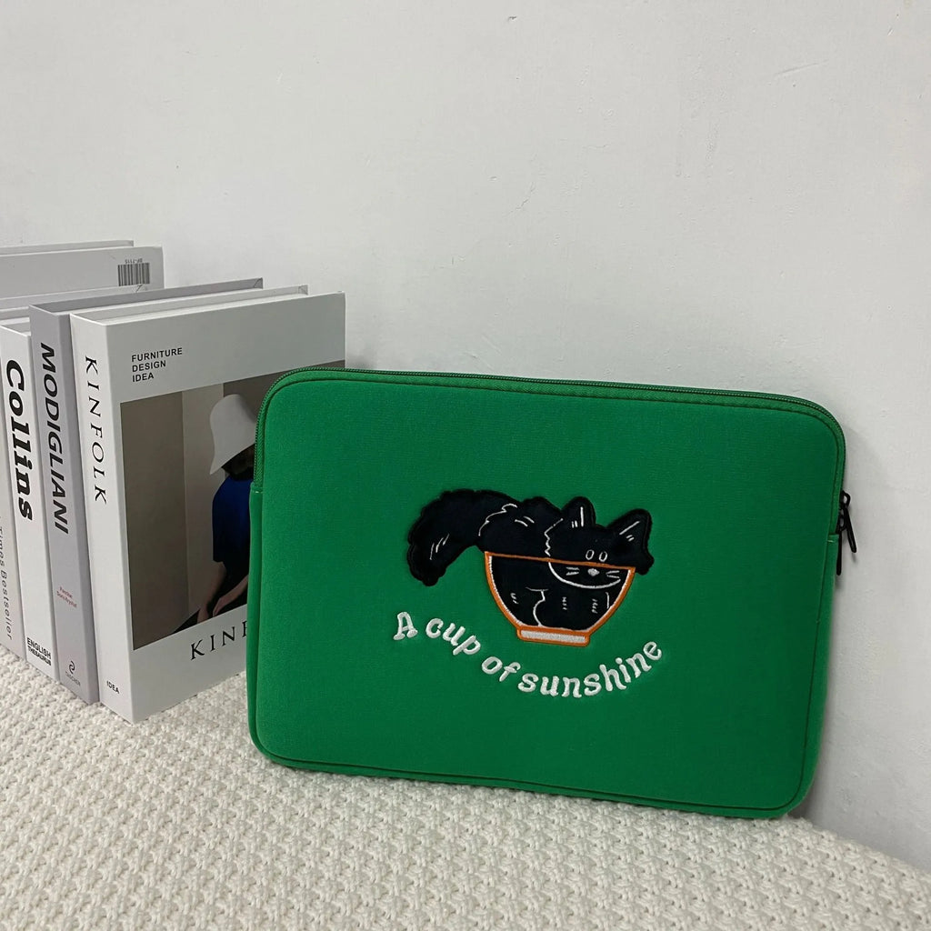 Embroidered laptop sleeve with animal design showing polyester construction and size options