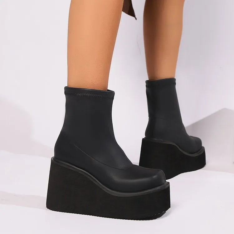 Black plus size women's wedge heel boots with a round toe and high cylinder shaft.
