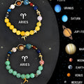 Set of two natural stone beaded bracelets with detailed zodiac sign charms on a white background.