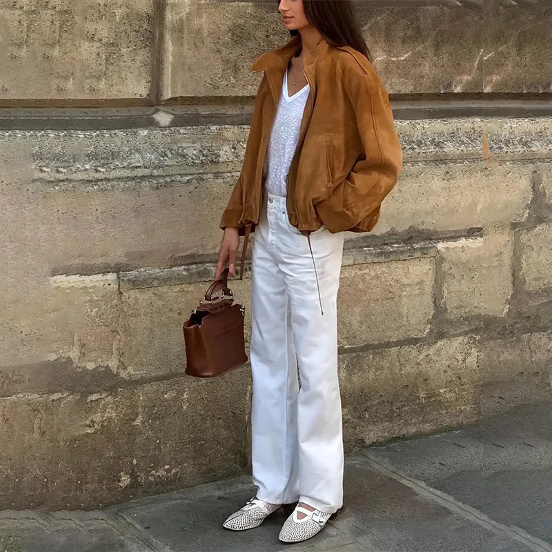 Loose fit solid colour retro jacket with long sleeves on a hanger.