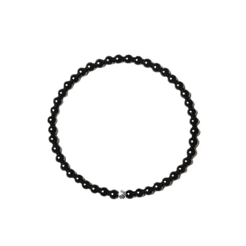 Geometric bracelet with obsidian, blue san and black agate beads showing round and chamfered square designs