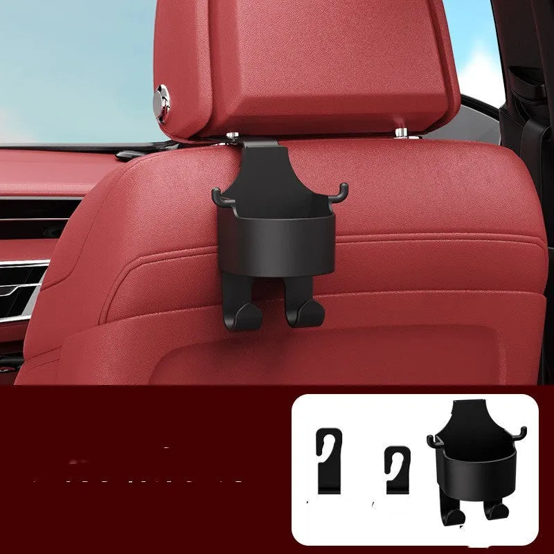 Black plastic car seat back hook organiser with cup holder mounted on vehicle headrest