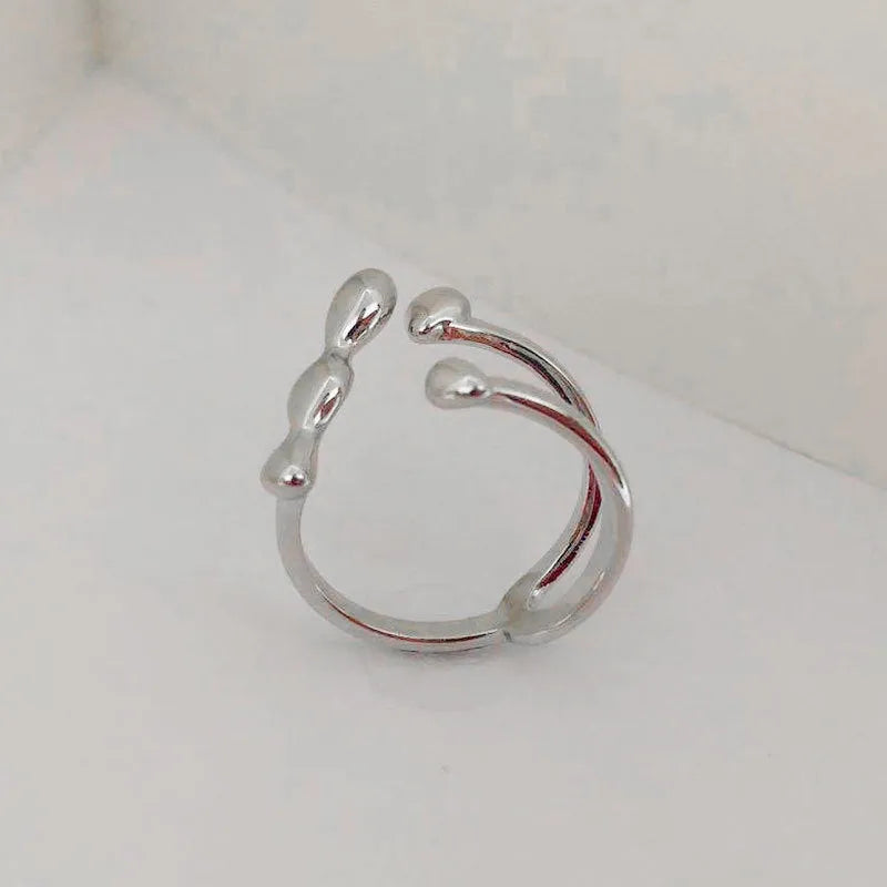 Gold brass opening ring with spherical decorative element on circular band