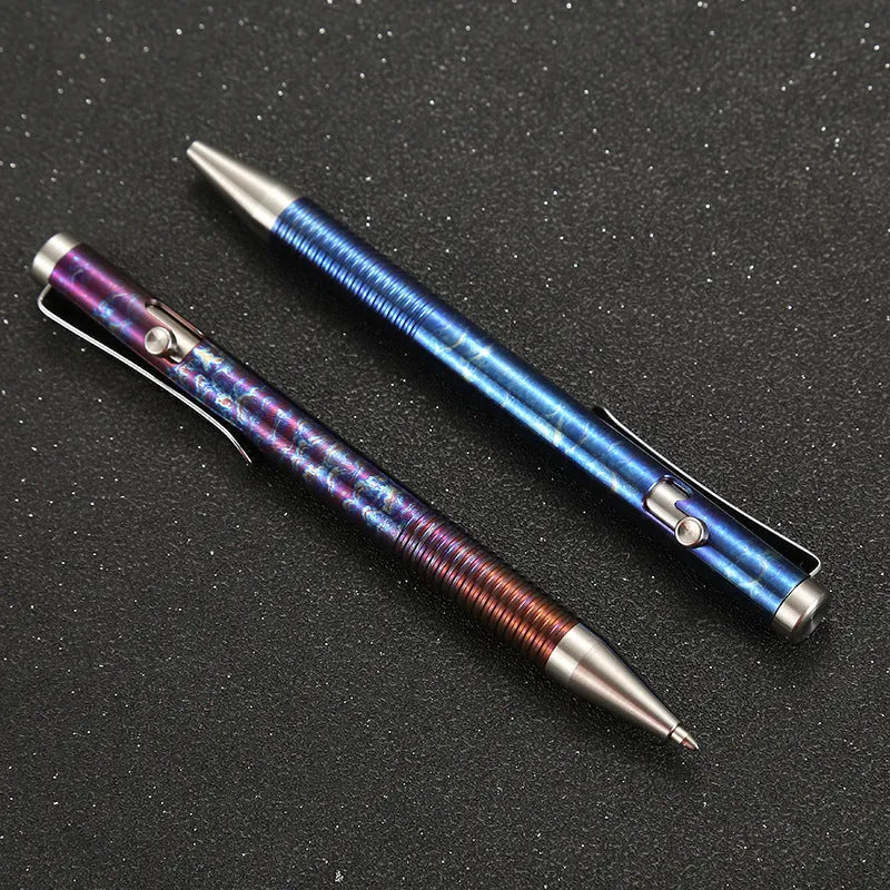 Titanium alloy gun bolt handle ball pen with magic colour phantom finish on a desk.