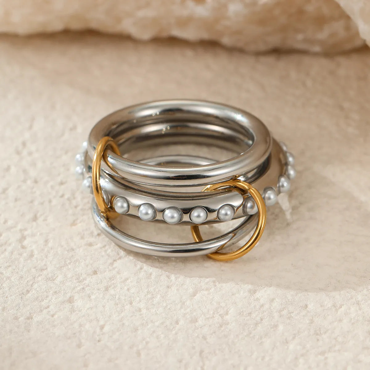 Gold plated stainless steel stacked ring set for women in an exaggerated free-size design.