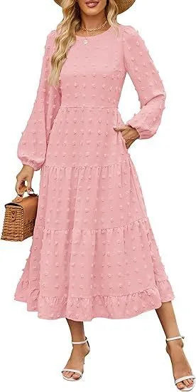 A woman wearing a beige high waist long sleeve dress with ruffle details on a autumn day.