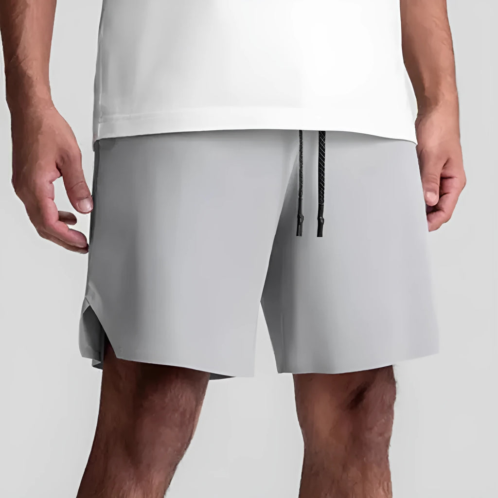 Men's quick-drying polyester sports shorts in knee length with multi-bag design, black colour, front view