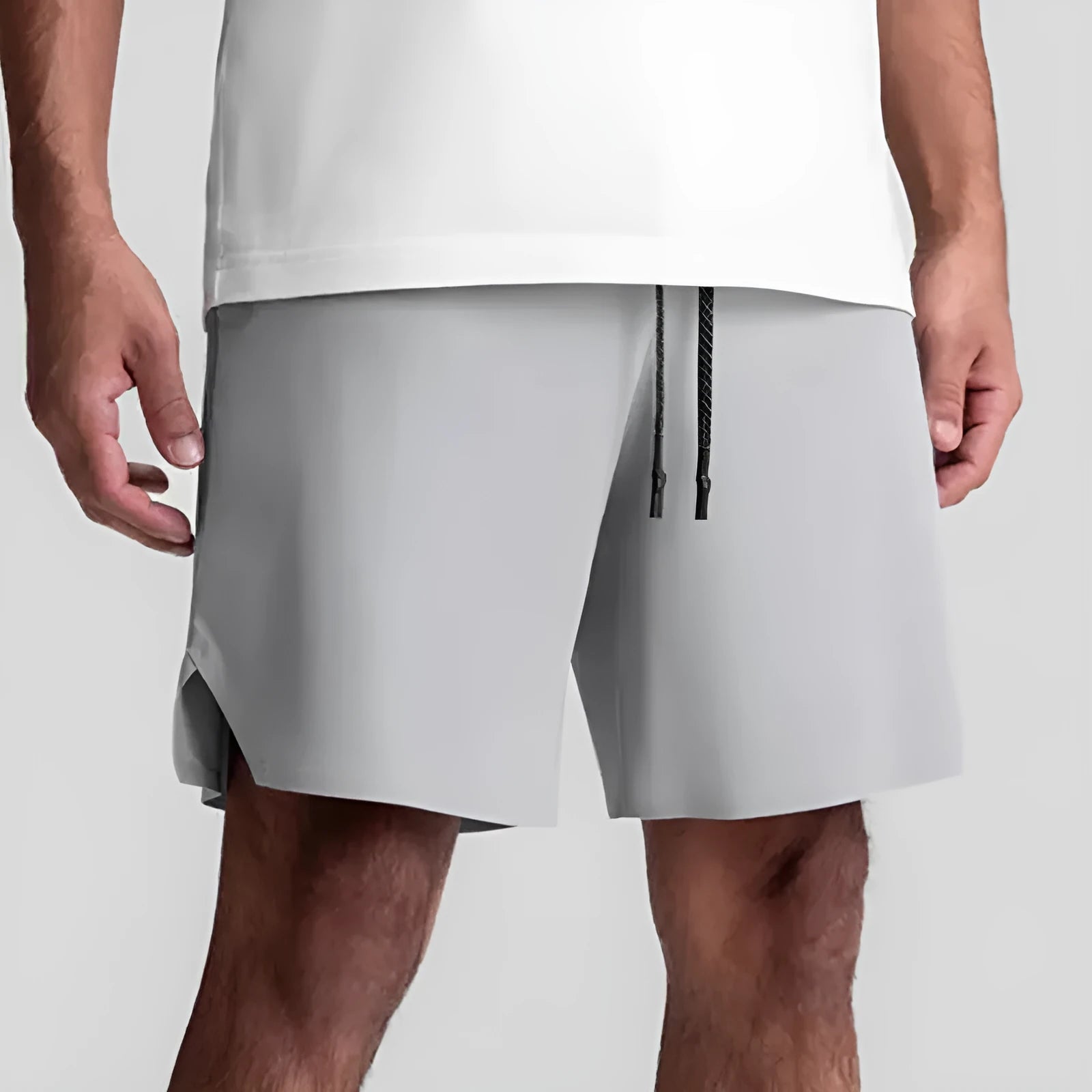 Men's quick-drying polyester sports shorts in knee length with multi-bag design, black colour, front view