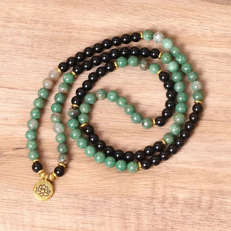 Green and black alloy beaded elastic bracelet laid flat showing alternating colour pattern