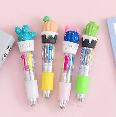 Cartoon-themed four-colour press ballpoint pen showing colour selection button and decorative designs