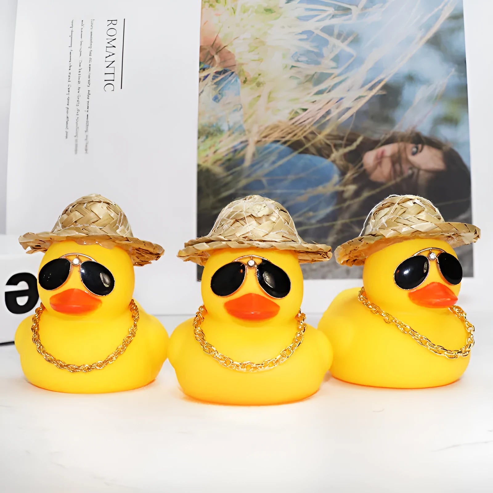 Yellow cartoon duck wearing a straw hat car dashboard ornament with adhesive and sunglasses accessory.