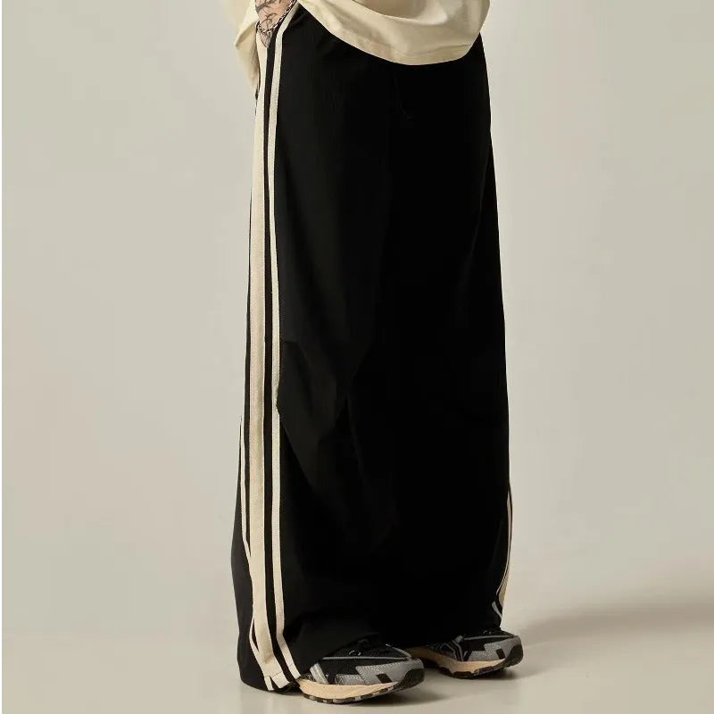 Black men's wide-leg climbing pants with a high waist and long straight-leg design on a neutral background.
