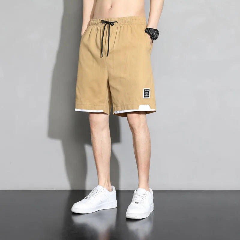 Boys' plus size cotton shorts in black, shown flat, featuring a mid waist and shorts length design.