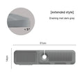Silicone faucet pad with sloped surface and two drains in beige colour on a kitchen sink