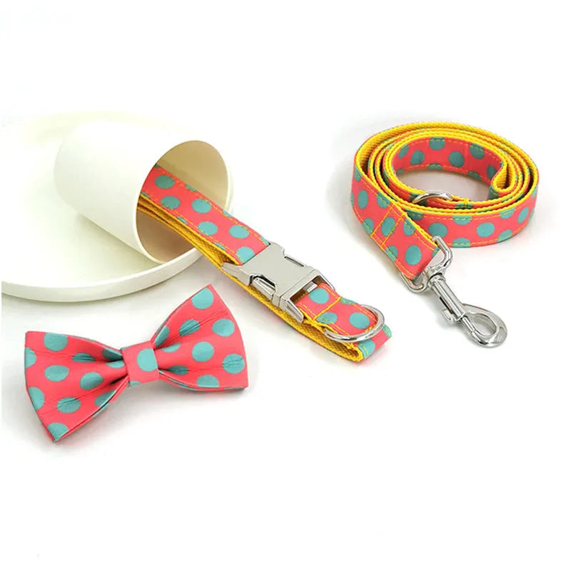 Yellow polka dot pet collar and matching hand-held traction rope lead set on plain background