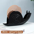 Plastic mosquito incense holder in black creative animal style on a table