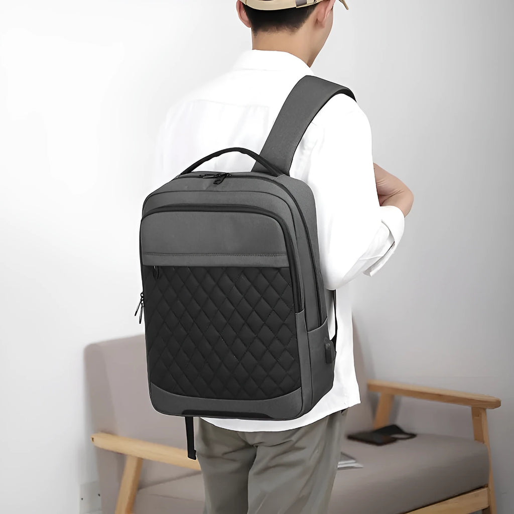 Men's black leisure travel backpack made from Oxford cloth with diamond mesh detail and curved shoulder straps