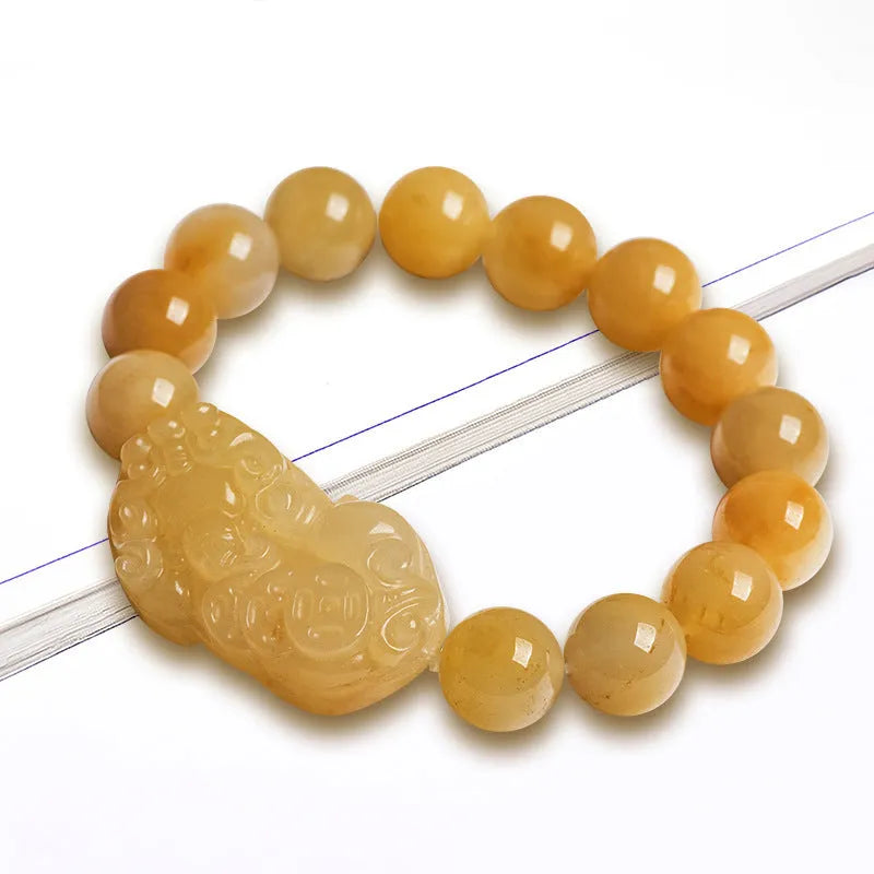 Carved golden thread jade money bracelet with traditional Chinese design showing detailed money motifs