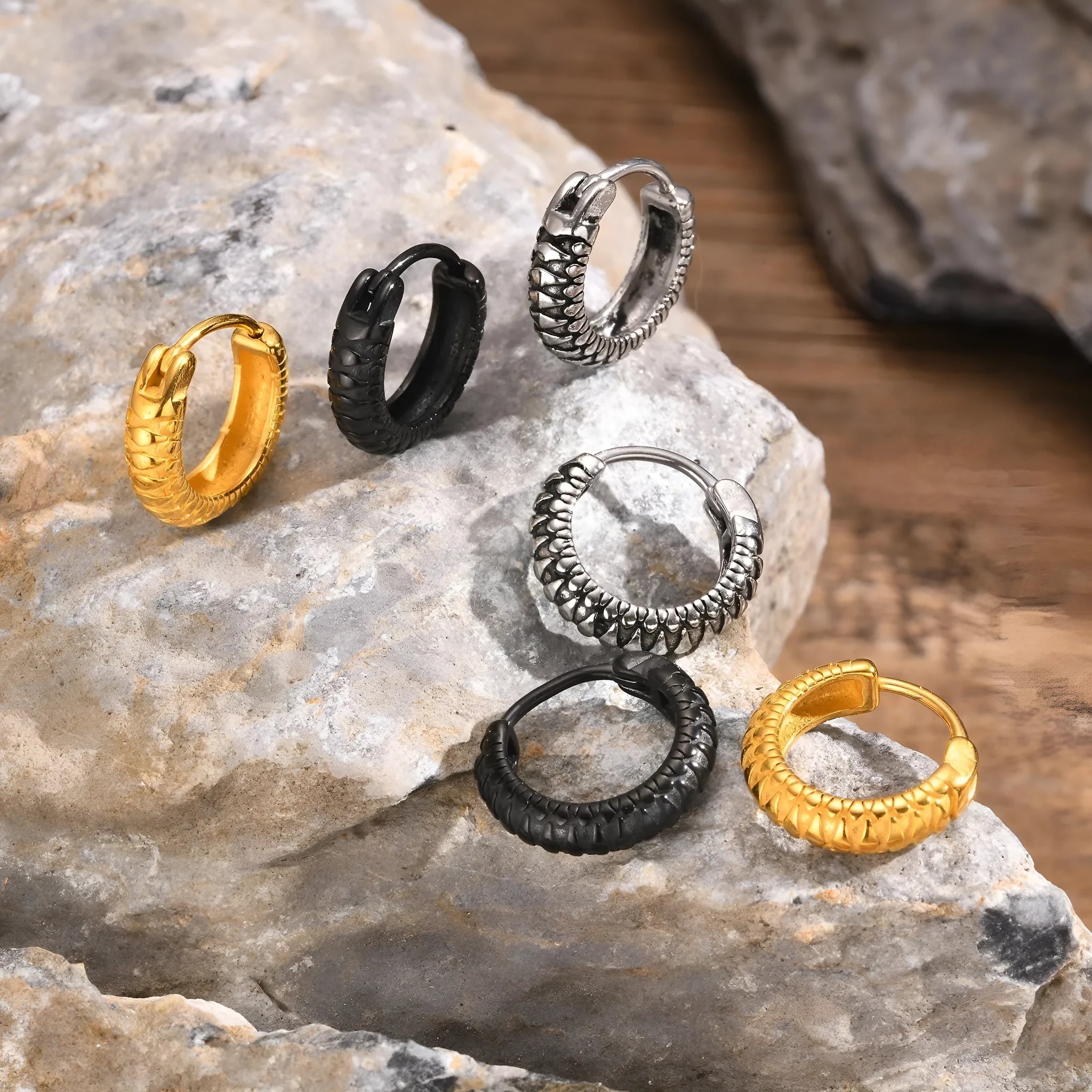 A pair of stainless steel snake pattern earrings in black or gold hip hop style.