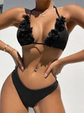 Black gathered polyester two-piece women's swimwear set with top and shorts on a model